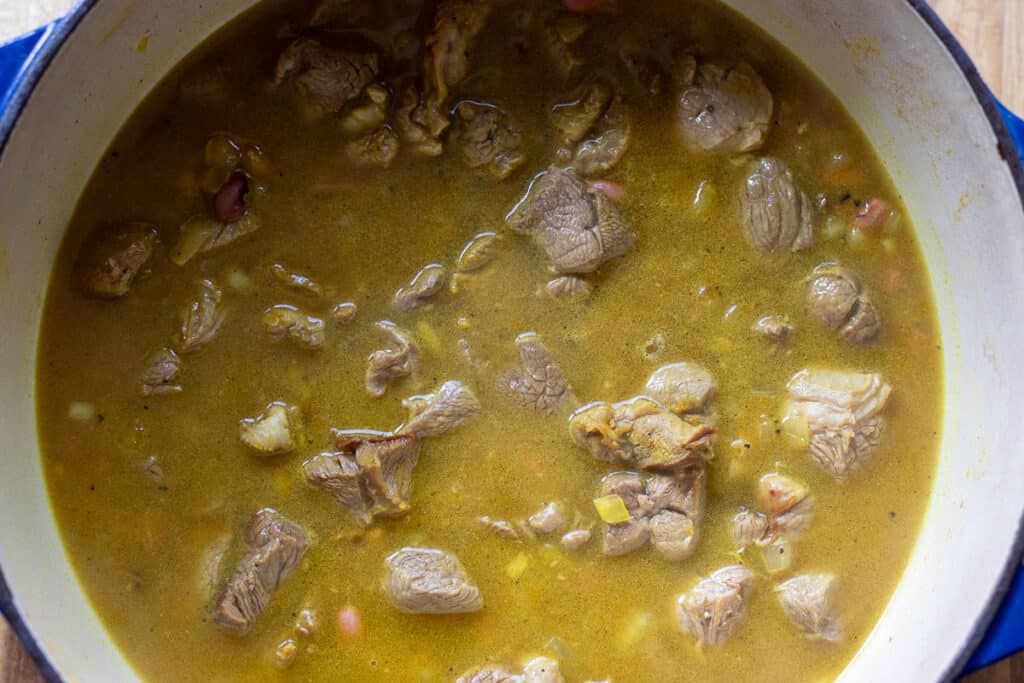 Water added to the sautéed onions and lamb.