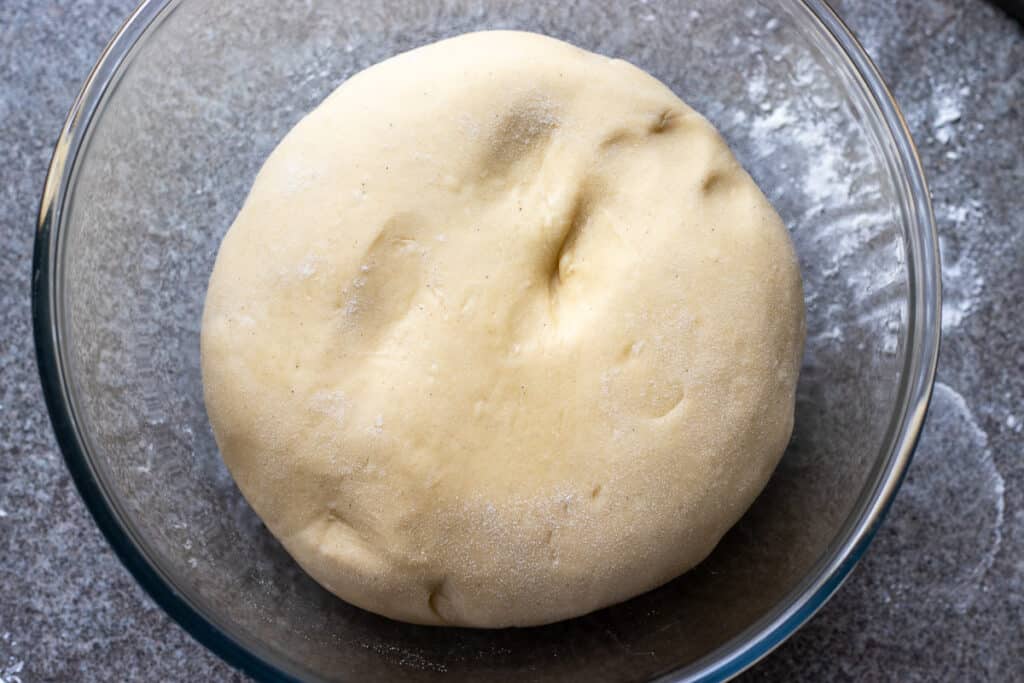 The dough is put in a bowl to rise.