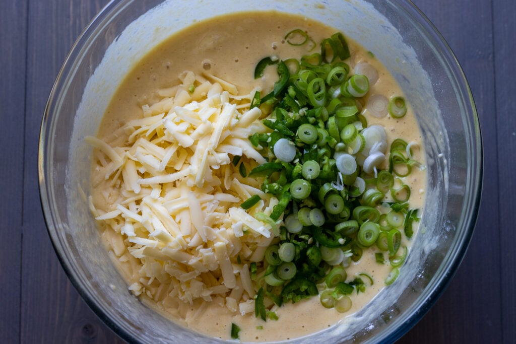 Sliced green onions, cheese, and jalapeño added to the cornbread batter.