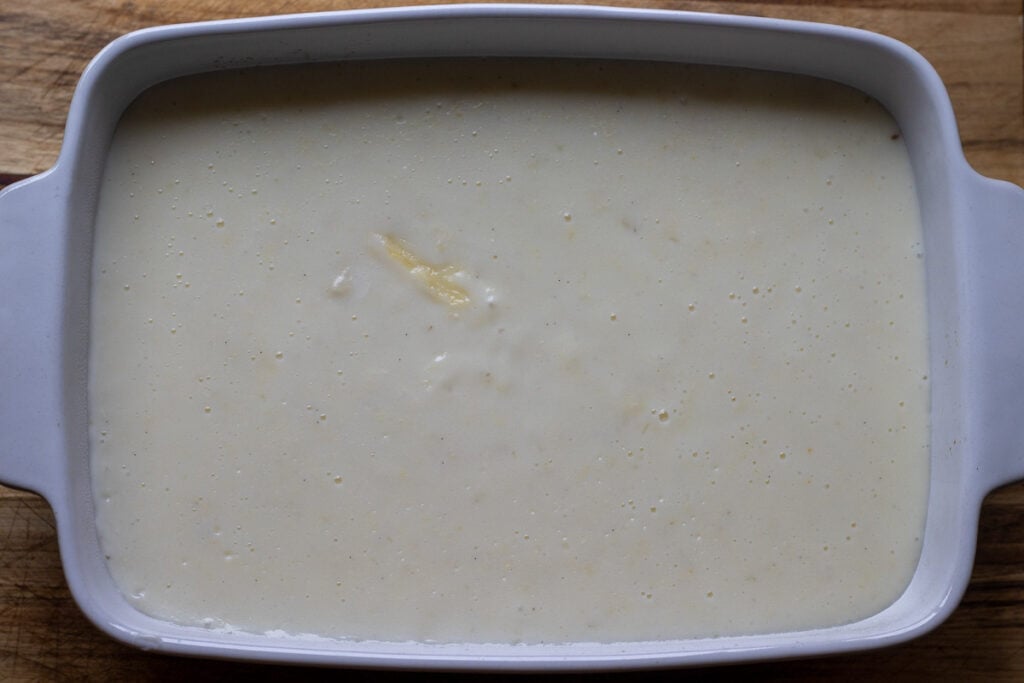 The pudding poured into a baking dish to set.