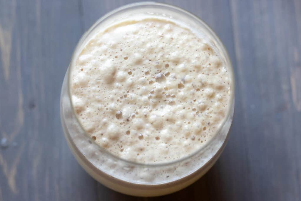 Water, sugar and yeast mixed in a glass.