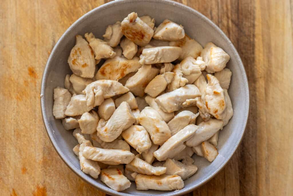 Seared chicken pieces resting in a bowl.