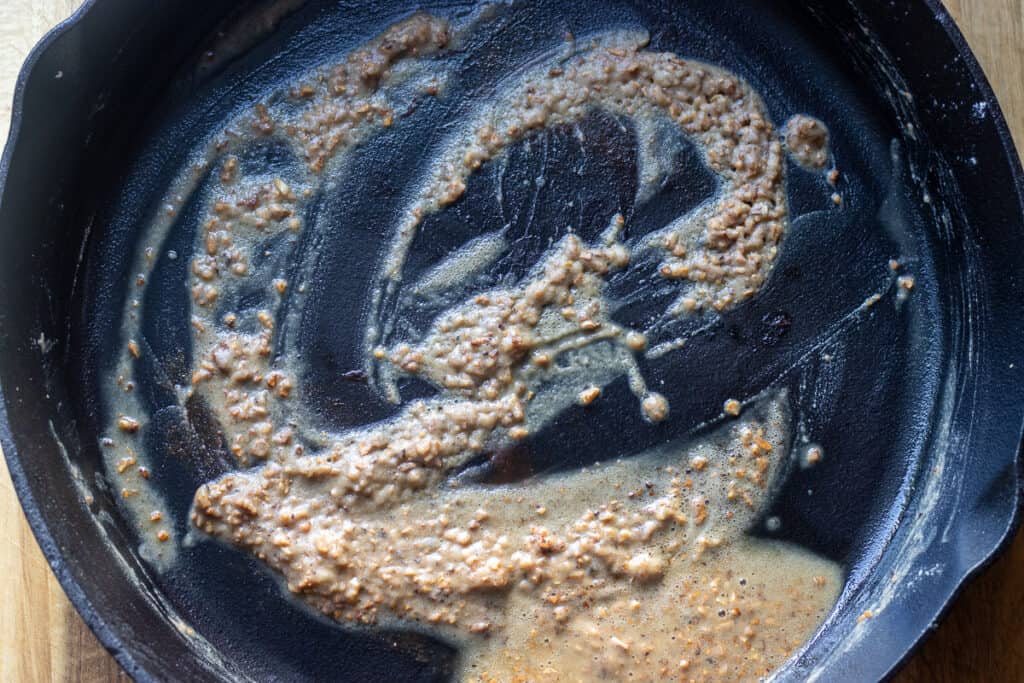 The flour and garlic are added to the melted butter to create a roux.