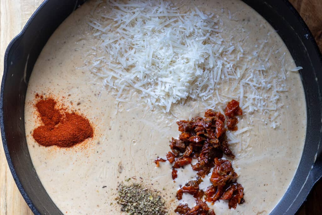 Paprika, sun-dried tomatoes, parmesan, and seasonings are added to the sauce.