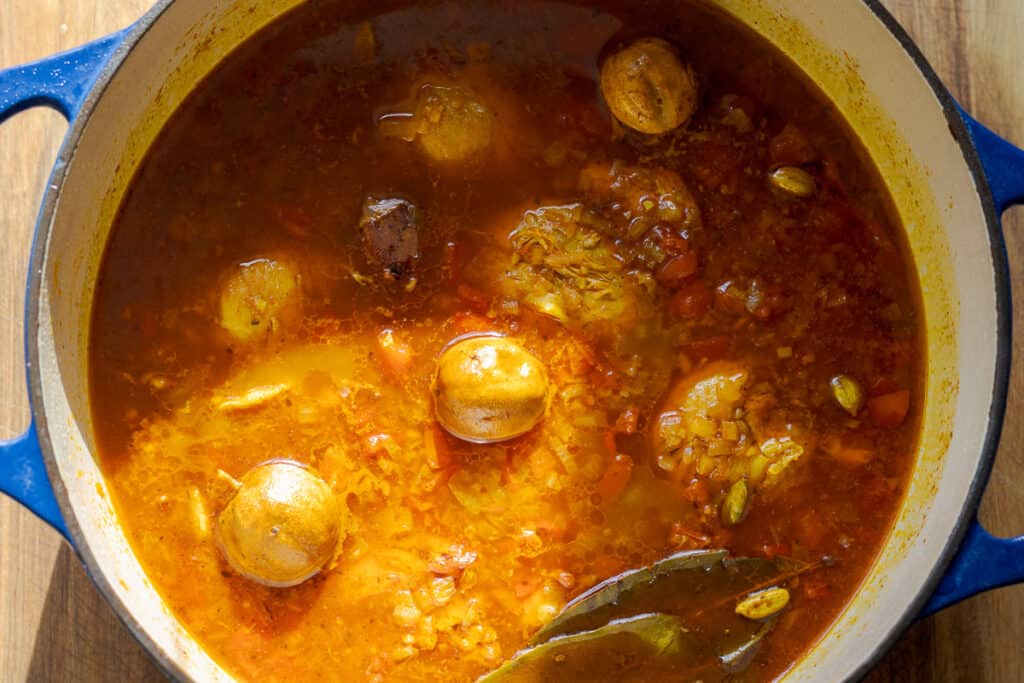 The stew is cooked until the chicken pieces are tender.