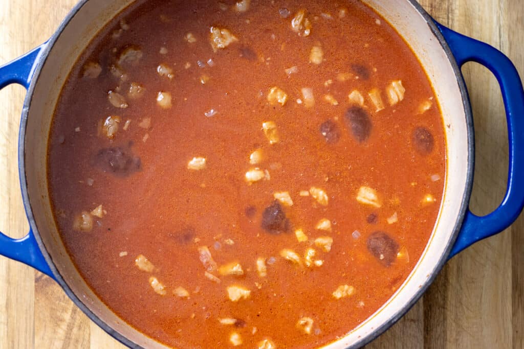 Tomato passata and stock poured into the pot.
