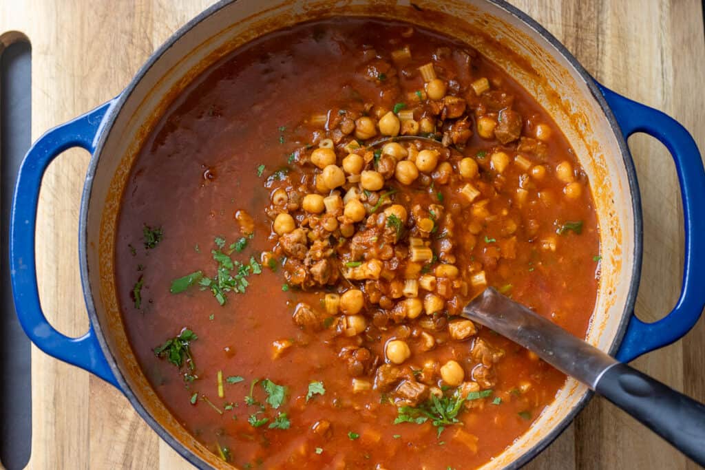The cooked soup, thick with lentils and chickpeas.