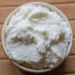 Overhead view of whipped toum - Lebanese garlic sauce in a bowl.