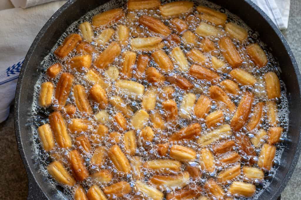 Dough pieces are brown and crispy, ready to dip in syrup.