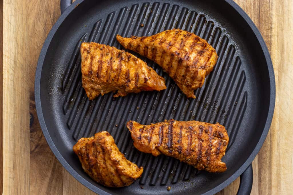 Seared turkey tenderloins in a skillet, ready to go into the oven.