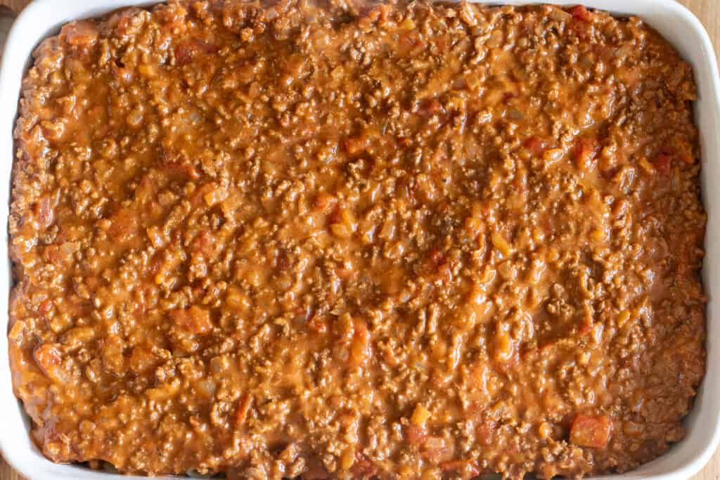 The meat sauce layered on top of the pasta.