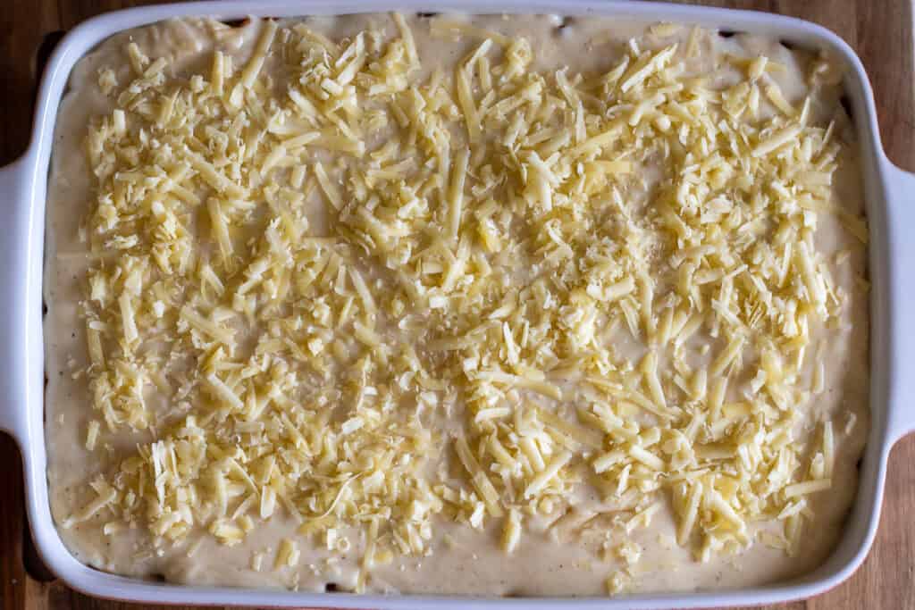 Béchamel sauce poured over the meat sauce and sprinkled with parmesan.