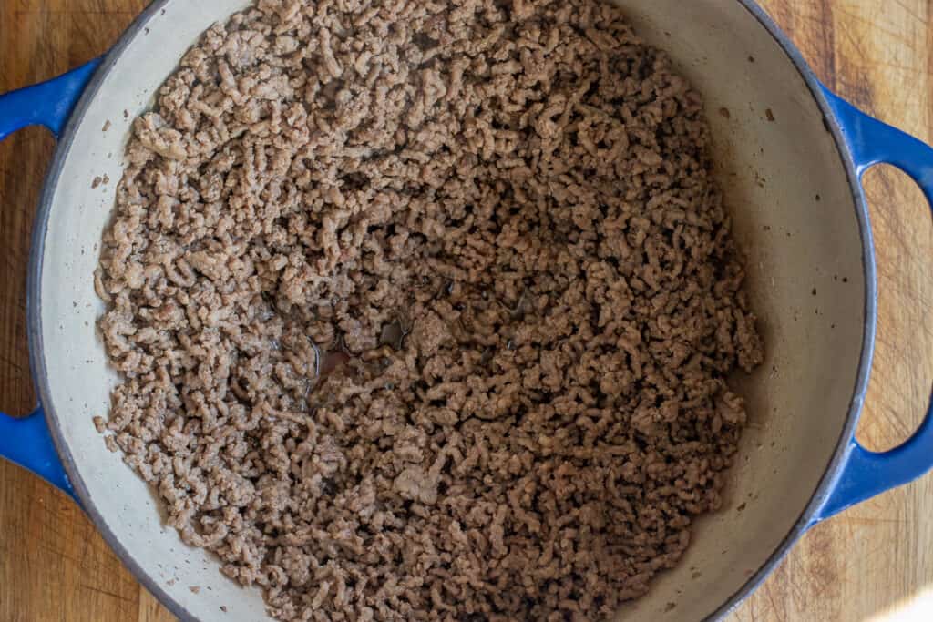 Browning the meat in a Dutch oven.