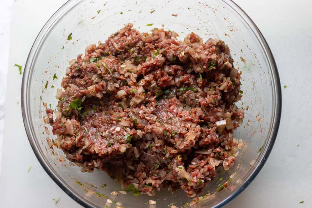 Meat and rice filling for stuffing the onion shells.