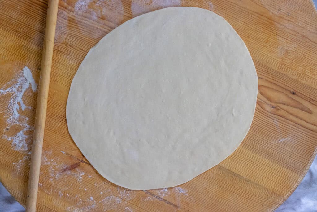One dough ball rolled out into a circle.