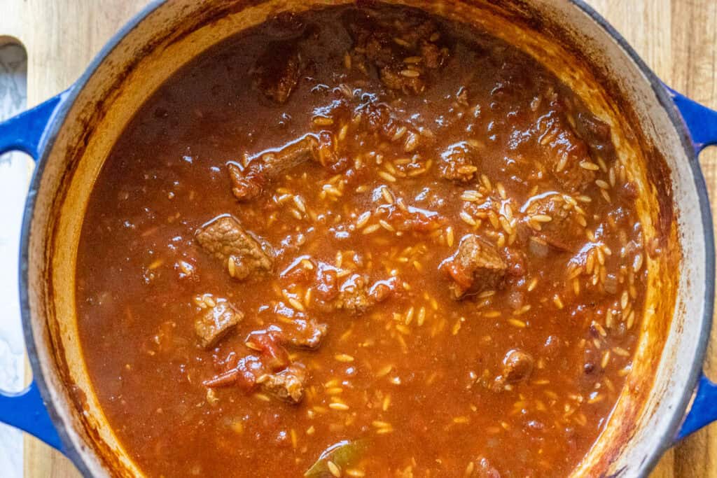 Orzo and more liquid are added to the stew.