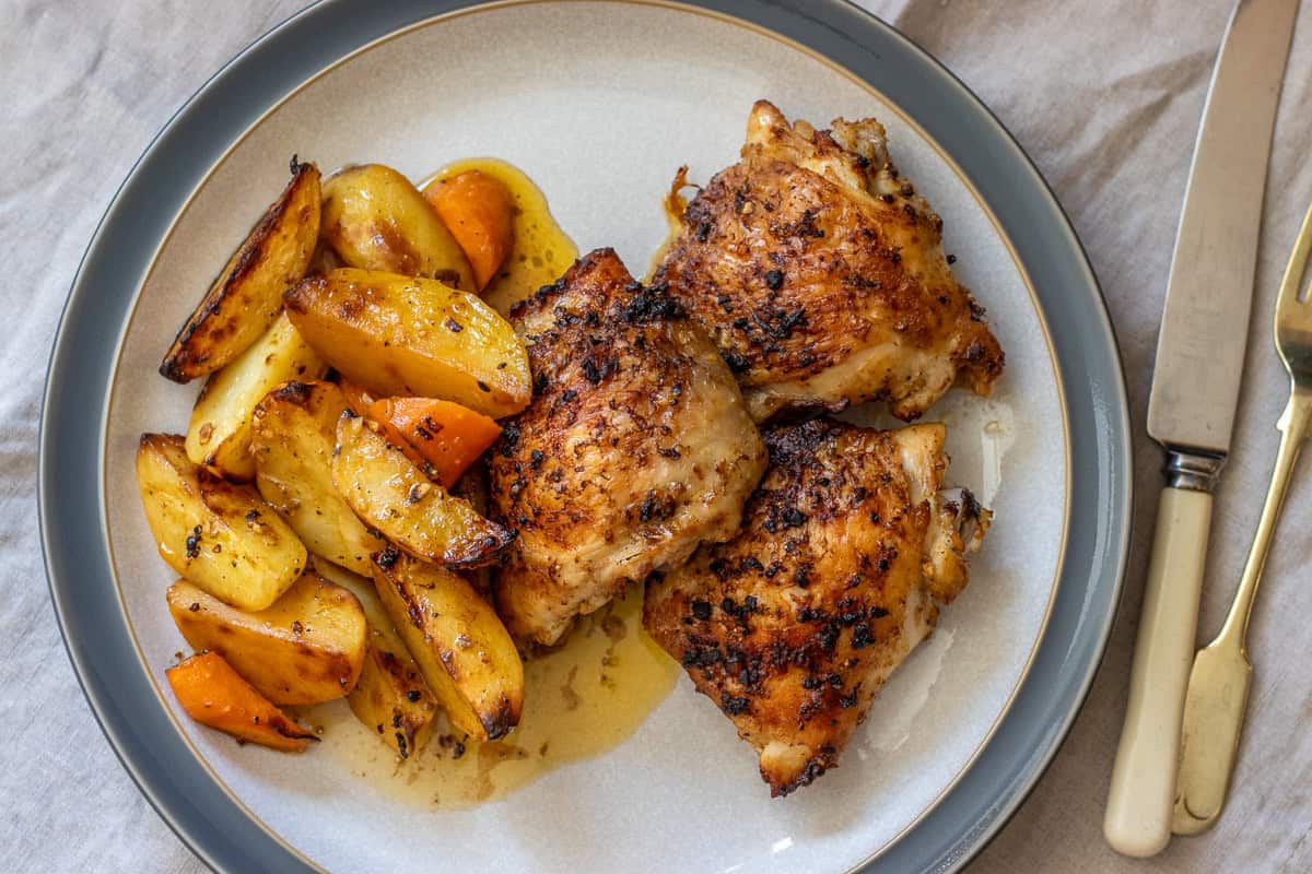 Chicken thighs with roasted potatoes and carrots.