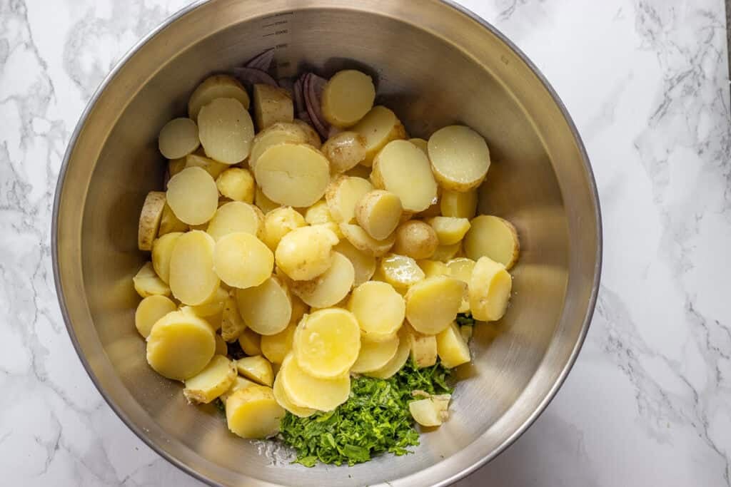 peeled potatoes are added to the bowl