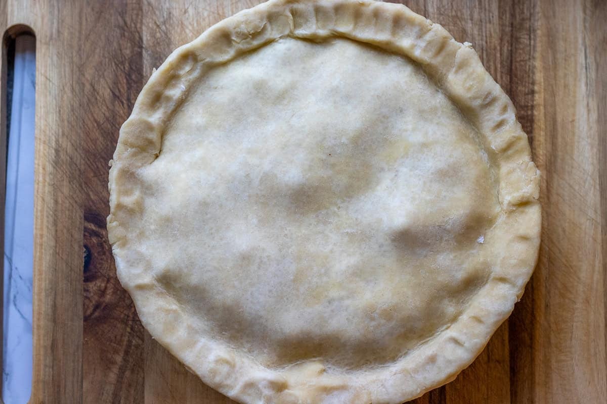turkey pie filling is covered with shortcrust pastry