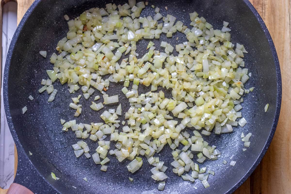 sauteing diced onions with olive oil for making turkey filling for leftover turkey pot
pie recipe