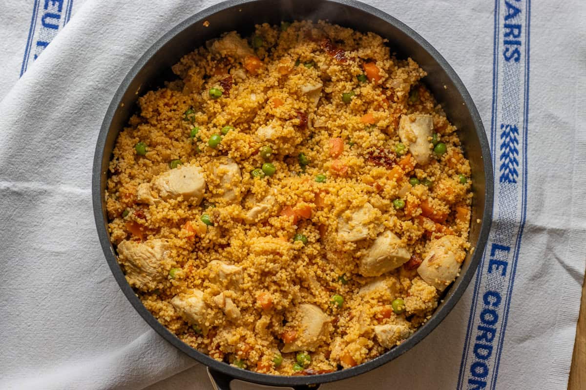 The cooked couscous is fluffed with a fork.