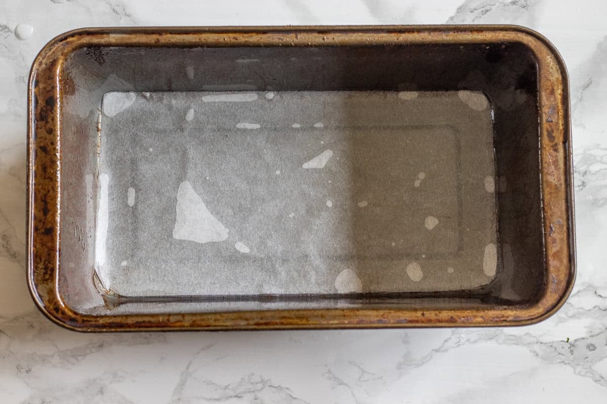 The bread loaf tin is lined with paper.