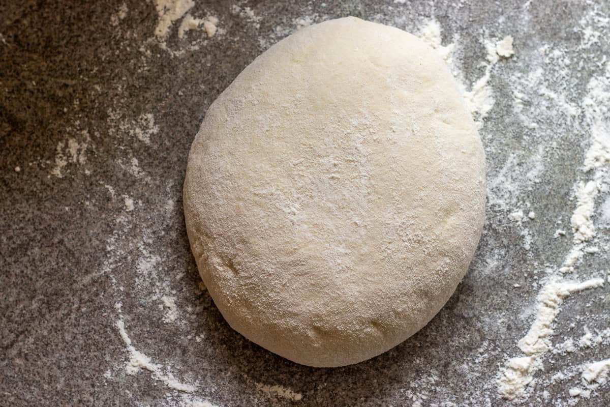 The bread dough is soft and smooth after kneading on the worktop.