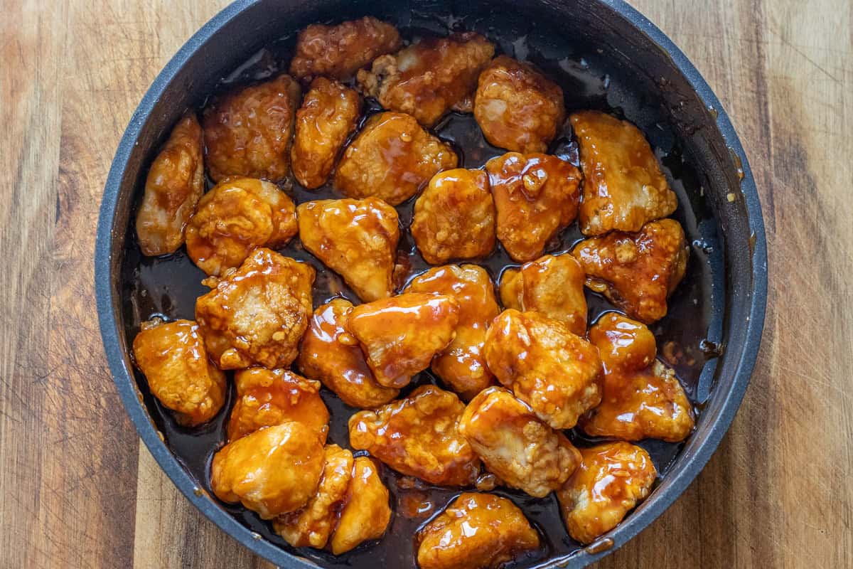 Crispy chicken pieces are coated with honey sauce.