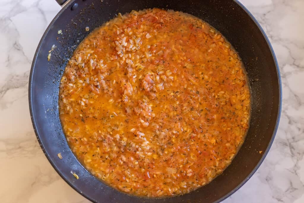 Tomato rice filling simmering in a pan.
