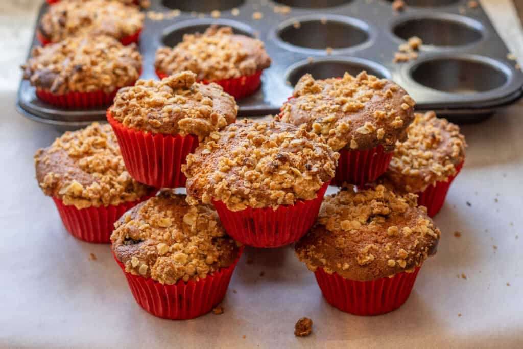 A stack of baked muffins in red paper liners.