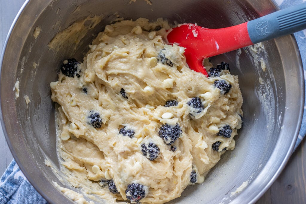 Berries and white chocolate folded into the thick batter.